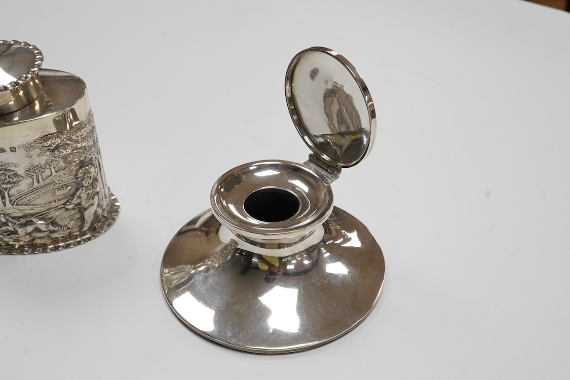 A late Victorian repousse silver oval tea caddy, by Nathan & Hayes, Chester, 1896, height 75mm, together with a George V silver mounted capstan inkwell.